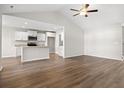 Open-concept living area with hardwood floors, vaulted ceilings, and a modern kitchen at 263 Stillbrook Dr., Longs, SC 29568
