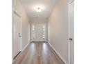 Bright entryway featuring wood-look flooring and a welcoming front door with sidelights at 268 Stillbrook Dr., Longs, SC 29568