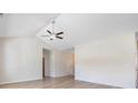 Spacious living room with vaulted ceilings, wood-look floors and modern ceiling fan at 268 Stillbrook Dr., Longs, SC 29568