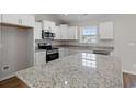 Modern kitchen featuring granite countertops, stainless steel appliances, and white cabinetry at 271 Stillbrook Dr., Longs, SC 29568