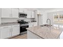Modern kitchen featuring stainless steel appliances, granite countertops, and white cabinets at 275 Stillbrook Dr., Longs, SC 29568