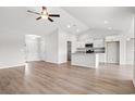 Open-concept living space with hardwood floors, and modern kitchen with island at 275 Stillbrook Dr., Longs, SC 29568
