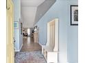 Inviting entryway with coat rack, light blue walls, and view into the living room with a fireplace at 284 Nature Trail, Little River, SC 29566