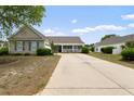 One-story home showcasing a well-maintained exterior and an ample driveway for parking at 3136 Robins Nest Way, Myrtle Beach, SC 29579