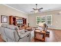 Relaxing living room features hardwood floors, abundant natural light, and a stylish ceiling fan at 3802 Seedling Ct., North Myrtle Beach, SC 29582