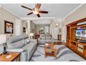 Inviting living room features a ceiling fan, hardwood floors, and neutral paint tones that enhance its appeal at 3802 Seedling Ct., North Myrtle Beach, SC 29582
