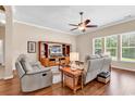 Comfortable living room boasts hardwood floors, ample natural light, and a modern ceiling fan for added comfort at 3802 Seedling Ct., North Myrtle Beach, SC 29582