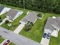 Birds eye view of a single-Gathering home with a large green lawn and white picket fence at 424 Enderby Way, Little River, SC 29566