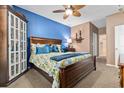 Cozy bedroom with blue accent wall, wooden furniture, carpeted floor and natural light providing comfortable retreat at 439 Colonial Trace Dr. # 119, Longs, SC 29568