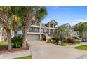 Stately two-story townhome boasts double balconies, beautiful landscaping and a garage at 4413 Plantation Harbour Dr. # A, Little River, SC 29566