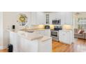 Bright kitchen features white cabinets, stainless steel appliances and hardwood floors at 4413 Plantation Harbour Dr. # A, Little River, SC 29566