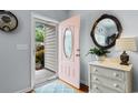 Foyer view with natural light, decorative mirror and white dresser at 4419 Kinlaw St., Little River, SC 29566