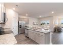 Modern kitchen with stainless steel appliances, a large center island, and an open floor plan at 4465 East Coast Ln., Shallotte, NC 28470