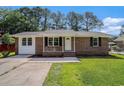 Charming brick home with a well-manicured front yard and a concrete driveway at 450 Player St., Georgetown, SC 29440