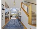 Spacious foyer with hardwood floors, staircase, and a view into the living room at 4616 Eyerly St., North Myrtle Beach, SC 29582