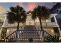 Charming two-story home with well-manicured landscaping, stair-accessed porch, and a two-car garage at 4616 Eyerly St., North Myrtle Beach, SC 29582