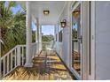 Inviting porch with white columns, rocking chairs, and a view of the surrounding landscape at 4616 Eyerly St., North Myrtle Beach, SC 29582
