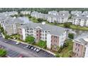 Condominium building surrounded by lush landscaping, a peaceful pond, and other residential buildings at 4887 Luster Leaf Circle # 105, Myrtle Beach, SC 29577
