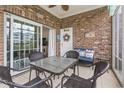 Cozy enclosed brick patio with seating and decorative elements at 4887 Luster Leaf Circle # 105, Myrtle Beach, SC 29577