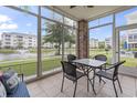 Enclosed patio with tiled flooring and a lovely view of the pond and surrounding landscaping at 4887 Luster Leaf Circle # 105, Myrtle Beach, SC 29577