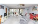 Cozy living room with neutral carpet, comfortable seating, and access to screened porches at 510 Fairwood Lakes Dr. # 17-P, Myrtle Beach, SC 29588