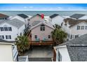 Charming coastal home with a large deck and palm trees, situated near a beautiful beach with ocean view at 6001 - B7 S Kings Hwy., Myrtle Beach, SC 29575