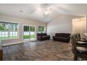 Large living room featuring hardwood floors, vaulted ceilings, and abundant natural light at 630 Heartwood Dr., Conway, SC 29526