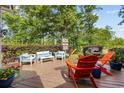 Relaxing back deck with comfortable seating area, grill, and well-manicured landscaping at 645 Boundary Line Dr. Nw, Calabash, NC 28467