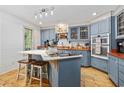 Beautiful kitchen featuring custom blue cabinets, butcher block countertops, and hardwood floors at 645 Boundary Line Dr. Nw, Calabash, NC 28467