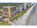 A high-angle view shows the beachside condo, oceanfront views, and a sandy beach at 6900 N Ocean Blvd. # 1437, Myrtle Beach, SC 29572