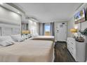 The guest bedroom has two double beds, a mounted TV, and access to the balcony at 6900 N Ocean Blvd. # 1437, Myrtle Beach, SC 29572