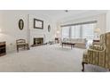 Bright living room with a fireplace, plush carpeting, and large windows at 931 Cedarwood Circle, Myrtle Beach, SC 29572