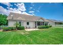 Expansive backyard featuring a well-maintained lawn, patio area, and privacy fencing, perfect for outdoor enjoyment at 100 Woodlyn Ave., Little River, SC 29566