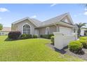 Well-maintained single-story home with a manicured lawn and beautiful shrubbery at 10106 Duval Dr., Murrells Inlet, SC 29576