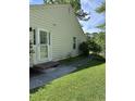 Exterior view of home with new siding and sidewalk leading to back yard at 105 Robin Ct., Murrells Inlet, SC 29576