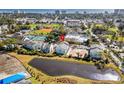 Aerial view of the property near tennis courts and a pond, highlighting the community amenities at 1100 Possum Trot Rd. # B202, North Myrtle Beach, SC 29582