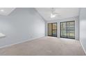 Bright living room with two sliding glass doors and neutral carpet, offering plenty of natural light at 1100 Possum Trot Rd. # B202, North Myrtle Beach, SC 29582