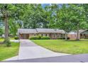 Well-maintained brick home with a long driveway and basketball hoop on a lush green lawn at 1108 Chicora Blvd., Conway, SC 29526
