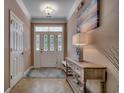 Elegant foyer with a decorative front door, tiled floor, and a stylish console table with lamp at 1204 Pine Valley Rd., North Myrtle Beach, SC 29582