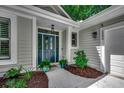 Inviting home entrance features a blue front door, charming plants, and attractive house number at 1204 Pine Valley Rd., North Myrtle Beach, SC 29582