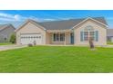 Well-maintained single-story home with blue shutters, inviting curb appeal, and a green front lawn at 125 Balsa Dr., Longs, SC 29568