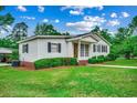 Charming one-story home with a well-manicured lawn, brick foundation and walkway at 1261 Parkhill Dr., Conway, SC 29526