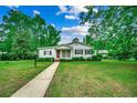 Charming one-story home with a well-manicured lawn, walkway and beautiful landscape at 1261 Parkhill Dr., Conway, SC 29526