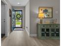 Bright entryway featuring modern flooring, calming paint colors, and a charming side table at 1307 Collins Park St., Conway, SC 29526
