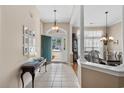 Welcoming foyer with tile flooring, complemented by a decorative table and an open view to the dining area at 190 Barony Pl., Pawleys Island, SC 29585