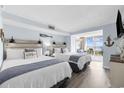 Bright bedroom featuring two beds, beach decor, balcony access and plenty of natural light at 2000 N Ocean Blvd. # 315, Myrtle Beach, SC 29577