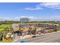 Overhead aerial view of resort buildings with palm trees, pool, parking, and surrounding green spaces at 201 Ocean Blvd. S # 1505, North Myrtle Beach, SC 29582