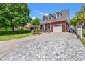 Lovely two-story brick home showcasing a driveway with a gray stone walkway at 2019 Ye Olde Kings Hwy., North Myrtle Beach, SC 29582