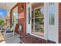 Close-up of a brick porch with rocking chairs and patriotic decorations at 2019 Ye Olde Kings Hwy., North Myrtle Beach, SC 29582