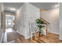 Hallway featuring stylish decor and a view of the front door, enhancing the home's charm at 202 Meadow Sweet Pl, Conway, SC 29526